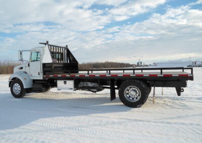 FLAT DECK TRAILER WITH WHITE TRUCK in winter